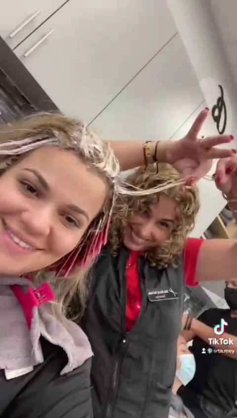 Clean salon interior with hair service stations.